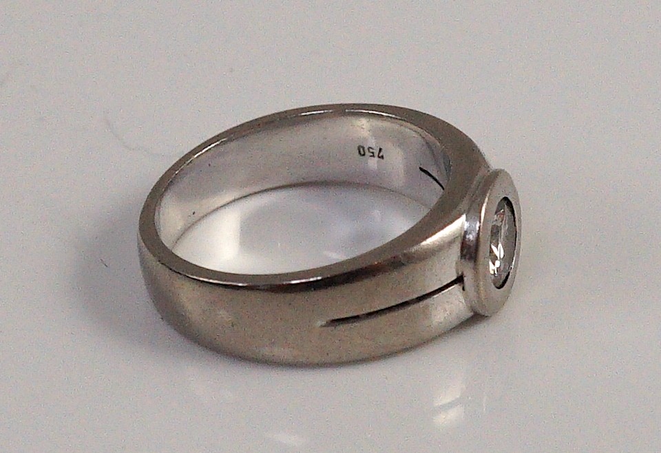 A modern 18k white gold and collet set solitaire diamond ring